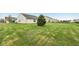 Expansive, well-maintained backyard featuring lush green grass and mature landscaping at 8660 Benjamin Ln, Avon, IN 46123