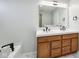 Bathroom featuring double sink vanity, soaking tub, and tile floors at 8660 Benjamin Ln, Avon, IN 46123