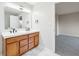 Bathroom featuring double sink vanity, tile floors, and good natural lighting at 8660 Benjamin Ln, Avon, IN 46123