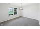 Light-filled bedroom with neutral carpet, modern light fixture, and large window at 8660 Benjamin Ln, Avon, IN 46123
