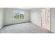 Bright, empty bedroom with a large window and en suite bathroom entrance at 8660 Benjamin Ln, Avon, IN 46123