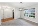 Dining room with large window, modern light fixture, and neutral carpet at 8660 Benjamin Ln, Avon, IN 46123