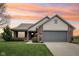 Charming single-Gathering home featuring a well-manicured lawn, brick accents, and an attached two-car garage at 8660 Benjamin Ln, Avon, IN 46123