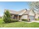 Charming home with a well-kept lawn, mature trees, and a brick-accented facade at 8660 Benjamin Ln, Avon, IN 46123