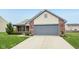 Home's front elevation featuring an attached two-car garage and brick detailing at 8660 Benjamin Ln, Avon, IN 46123