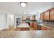 Bright kitchen with stainless steel appliances, large granite island, and adjoining dining area at 8660 Benjamin Ln, Avon, IN 46123
