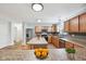 Bright kitchen with stainless steel appliances, large granite island, and adjoining dining area at 8660 Benjamin Ln, Avon, IN 46123