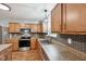 Updated kitchen features stainless steel appliances, hexagon tile backsplash, and granite countertops at 8660 Benjamin Ln, Avon, IN 46123