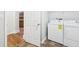 Bright laundry area showcasing modern, white appliances conveniently located near kitchen entrance at 8660 Benjamin Ln, Avon, IN 46123