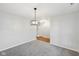 Bright and spacious living room with neutral carpet and modern light fixture at 8660 Benjamin Ln, Avon, IN 46123