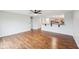 Spacious open-concept living room featuring hardwood floors and a partial view of the kitchen at 8660 Benjamin Ln, Avon, IN 46123