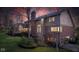 View of the large brick home's backyard featuring a deck, mature trees, and well-maintained landscaping at 8939 Spider Bay Ct, Indianapolis, IN 46236