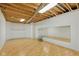Basement workout area features wood flooring, mirrors, and exposed ductwork for a modern feel at 8939 Spider Bay Ct, Indianapolis, IN 46236