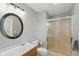 Bathroom featuring a vanity with a round mirror, a shower, and a toilet at 8939 Spider Bay Ct, Indianapolis, IN 46236