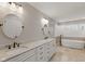 Bright bathroom showcasing a double vanity, soaking tub, and neutral color palette at 8939 Spider Bay Ct, Indianapolis, IN 46236