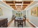 Elegant dining room featuring a coffered ceiling, chandelier, and a large table with seating for ten at 8939 Spider Bay Ct, Indianapolis, IN 46236