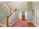 Grand foyer with hardwood floors, a staircase, and an elegant chandelier creating a welcoming entrance at 8939 Spider Bay Ct, Indianapolis, IN 46236