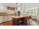 Spacious kitchen island with granite countertops, seating, stainless appliances and hardwood floors at 8939 Spider Bay Ct, Indianapolis, IN 46236