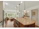 Open-concept kitchen featuring a bar area, large island, and stainless appliances, bathed in natural light at 8939 Spider Bay Ct, Indianapolis, IN 46236