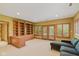 Spacious living room features custom built-in bookshelves and multiple French doors leading to the outside at 8939 Spider Bay Ct, Indianapolis, IN 46236