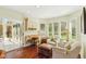 Sun-lit sitting room with a custom built in desk, plenty of natural light and hardwood flooring at 8939 Spider Bay Ct, Indianapolis, IN 46236