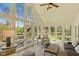 Bright sunroom with floor-to-ceiling windows, providing panoramic views and ample seating at 8939 Spider Bay Ct, Indianapolis, IN 46236
