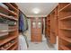 Walk-in closet featuring custom shelving, drawers, and ample storage space at 8939 Spider Bay Ct, Indianapolis, IN 46236