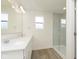 Bright bathroom featuring double sinks, a glass enclosed shower, and modern finishes at 9738 Behner Dr, Fishers, IN 46250