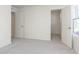 Bedroom featuring neutral carpeting with a doorway to a walk-in closet, and a large window at 9738 Behner Dr, Fishers, IN 46250