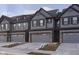 New construction townhouse featuring a gray exterior, attached garage, and manicured lawn at 9738 Behner Dr, Fishers, IN 46250