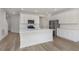 Spacious kitchen with a large center island, stainless appliances, and wood flooring at 9738 Behner Dr, Fishers, IN 46250