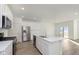 Modern kitchen with stainless steel appliances, a large island, and hardwood floors at 9738 Behner Dr, Fishers, IN 46250