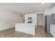Open kitchen featuring an island, stainless steel appliances, and wood floors at 9738 Behner Dr, Fishers, IN 46250