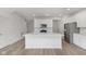 Modern kitchen with stainless steel appliances, a large island, and hardwood floors at 9738 Behner Dr, Fishers, IN 46250