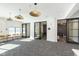 Open lobby with stylish pendant lighting, comfortable seating, and easy access to private office spaces at 9738 Behner Dr, Fishers, IN 46250