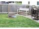 The backyard has an outside seating area, a fire pit and a wood rack full of wood near the privacy fence at 981 Redwood Dr, Franklin, IN 46131