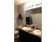 Bathroom with dual sinks, modern fixtures, a framed mirror, and storage at 981 Redwood Dr, Franklin, IN 46131