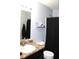 Clean bathroom featuring a modern vanity, a well-lit mirror, and shower with dark curtain creating a fresh atmosphere at 981 Redwood Dr, Franklin, IN 46131