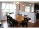 Bright dining room with a large wooden table and ample seating beside a window at 981 Redwood Dr, Franklin, IN 46131