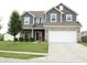 Inviting two-story home with a manicured lawn and a two-car garage at 981 Redwood Dr, Franklin, IN 46131