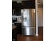 Stainless steel refrigerator in kitchen with dark cabinets and tile flooring at 981 Redwood Dr, Franklin, IN 46131