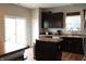 The kitchen boasts dark cabinets and an island near the sliding glass door at 981 Redwood Dr, Franklin, IN 46131