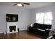 Inviting living room with a fireplace, dark sofa, and natural light at 981 Redwood Dr, Franklin, IN 46131