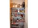 Organized pantry with wire shelving stocked with various food items and containers for optimal storage and access at 981 Redwood Dr, Franklin, IN 46131