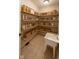 Well-organized pantry features natural wood shelves, baskets, and a utility sink for added convenience at 9877 Wading Crane Ave, Fishers, IN 46055