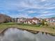 Backyard view showcasing pond access and community at 9877 Wading Crane Ave, Fishers, IN 46055