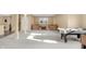 Finished basement with open seating area, stairs and game tables at 9877 Wading Crane Ave, Fishers, IN 46055