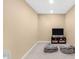 Finished basement bonus room complete with TV, shelving and comfortable seating at 9877 Wading Crane Ave, Fishers, IN 46055