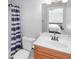Bathroom featuring a shower-tub combo, toilet, and vanity with wooden drawers at 9877 Wading Crane Ave, Fishers, IN 46055