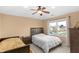 Bedroom featuring carpeted floors, ceiling fan, and large window at 9877 Wading Crane Ave, Fishers, IN 46055